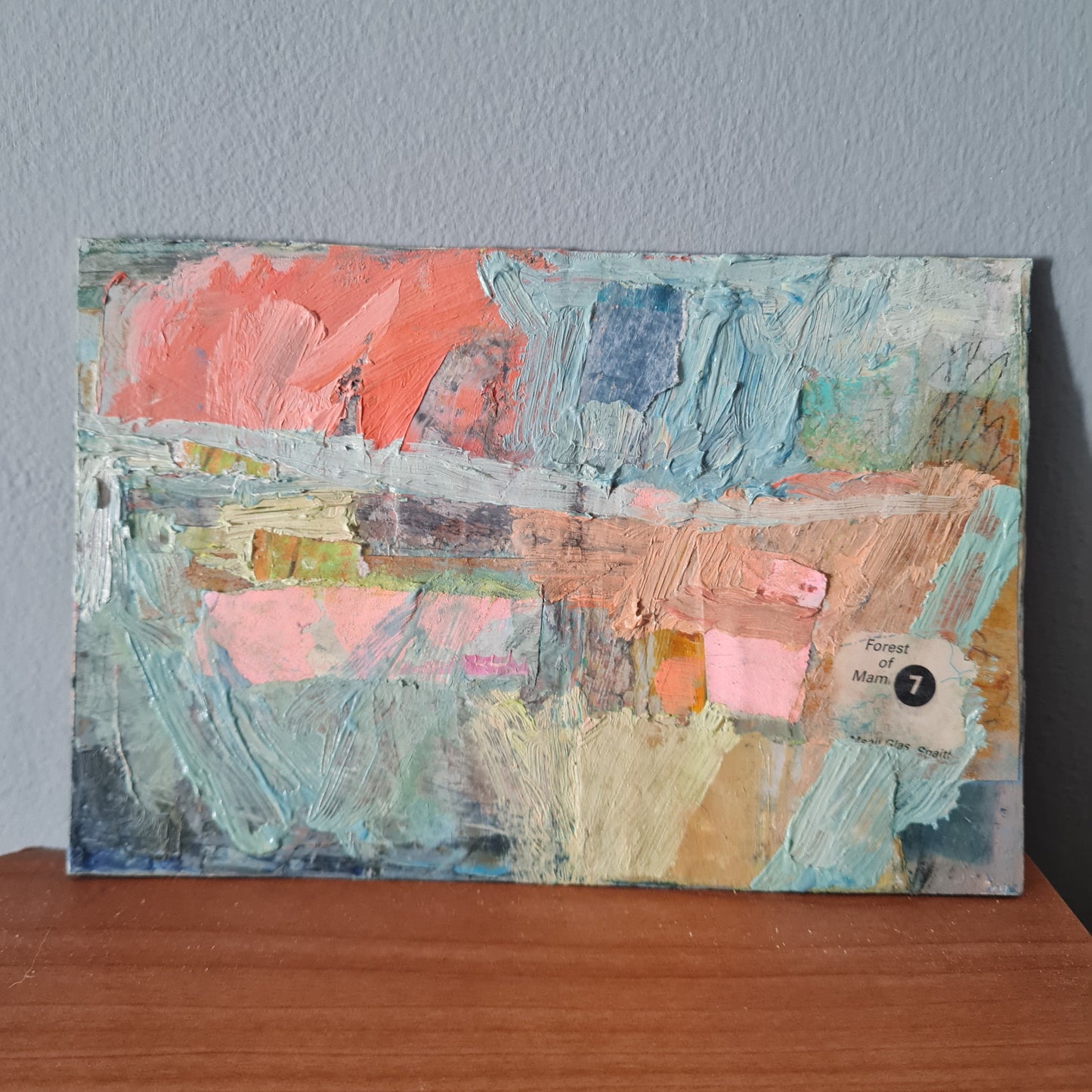 Abstract art piece with colorful brush strokes on a textured surface