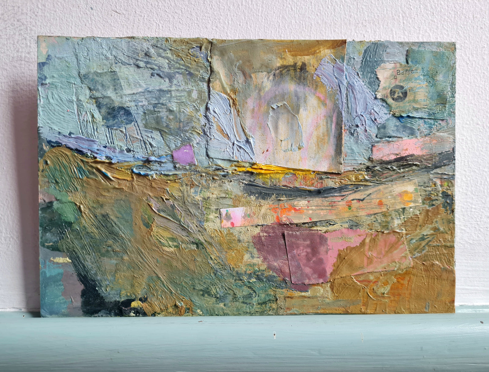 Abstract painting with textured brushstrokes on a white wall