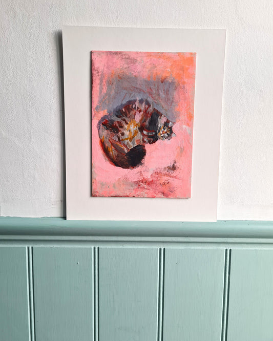 Contemporary cat painting on cream mounting board displayed on a white wall with blue painted tongue and groove woodwork below.