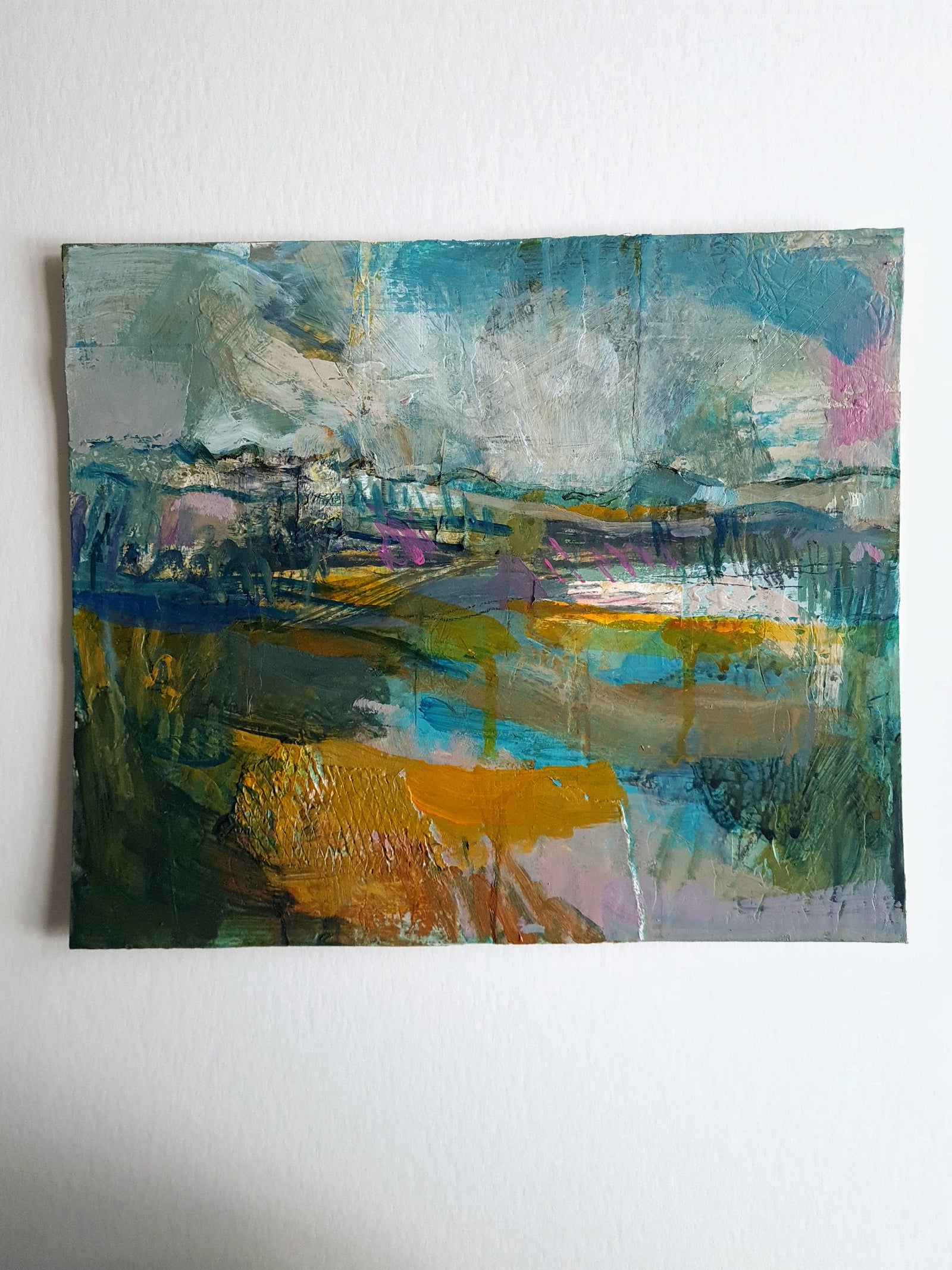 Abstract painting with colourful brush strokes on a white table