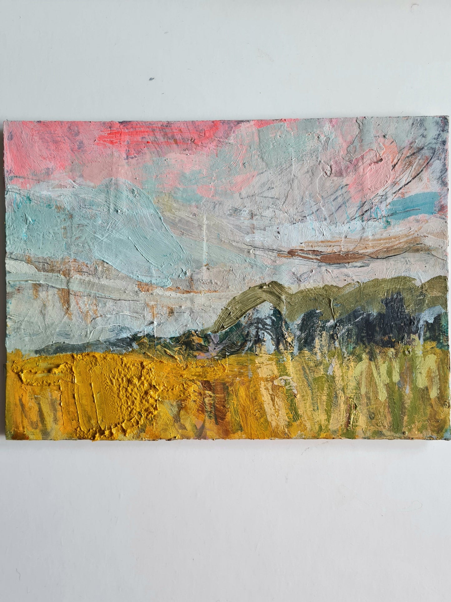 Abstract painting with a landscape of trees and fields on a white wall.