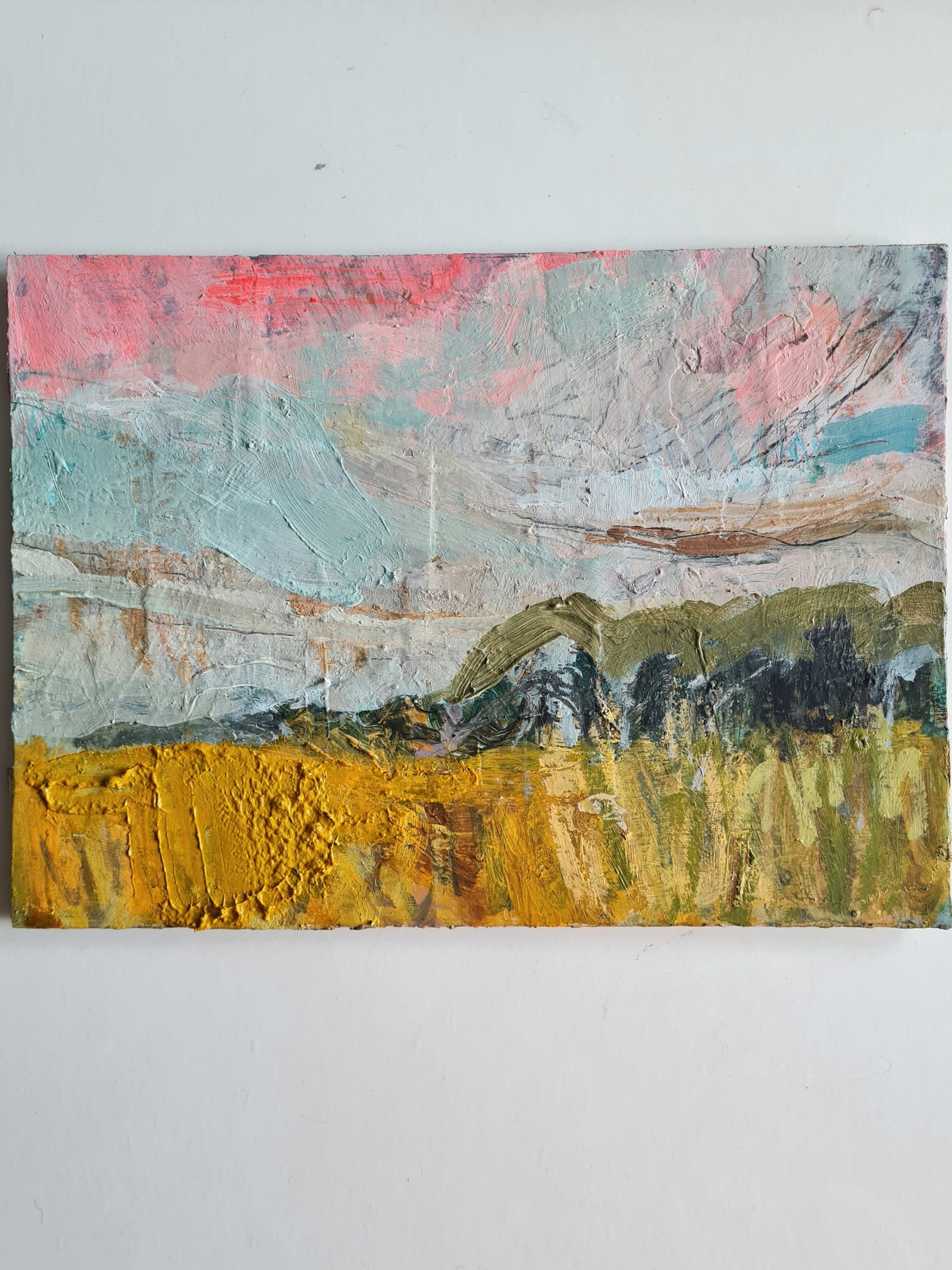 Abstract painting with a landscape of trees and fields on a white wall.