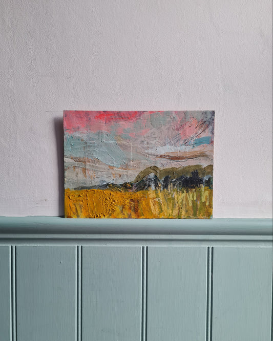 Abstract painting on a white wall and pale blue painted wooden panelling