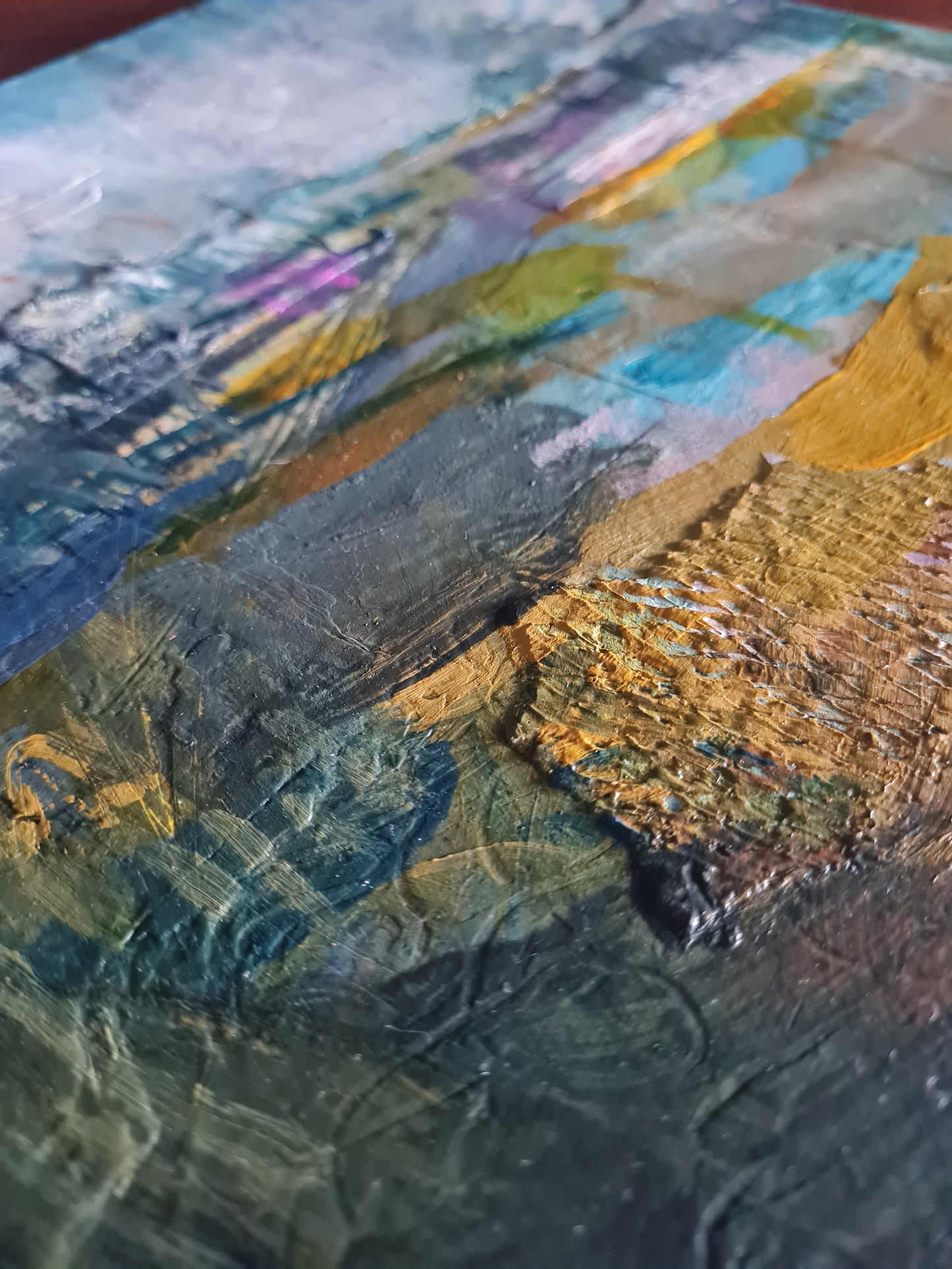 Close-up of a textured painting with earthy tones.
