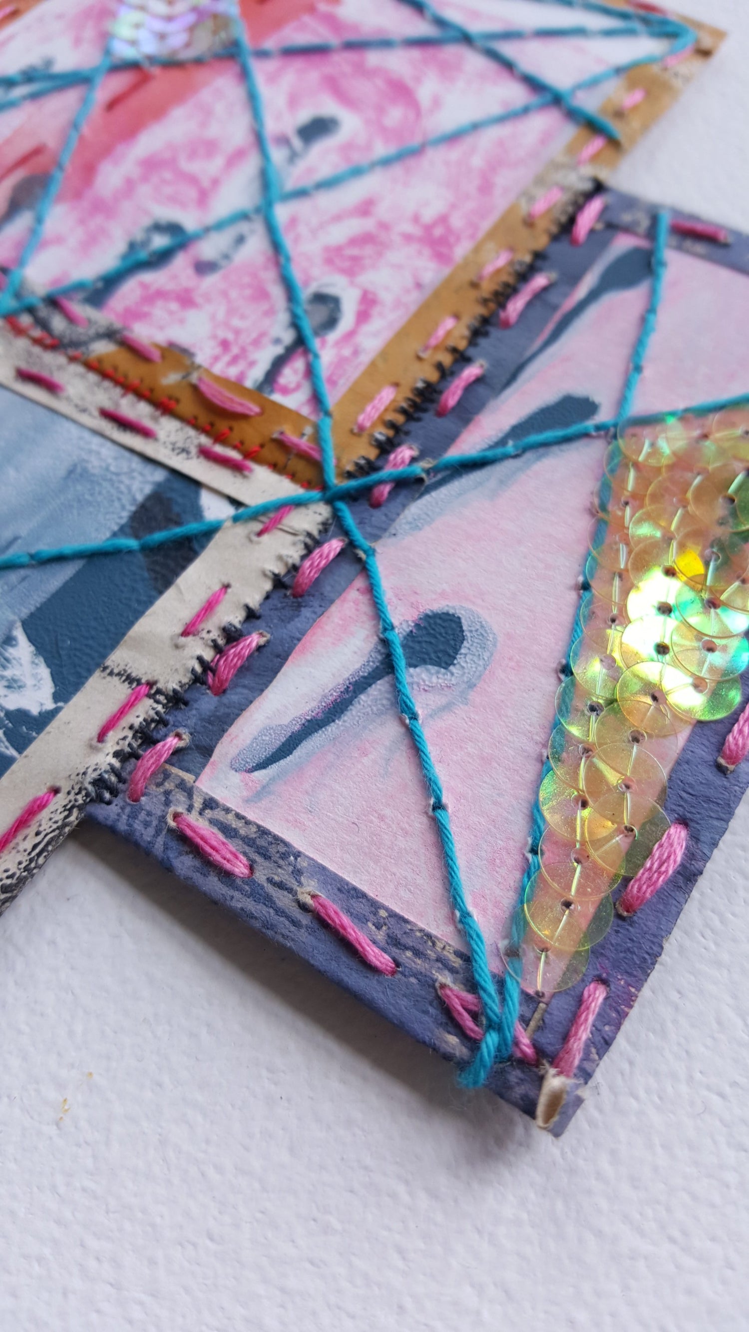 close up of sequins and embroidery on paper by Julia Laing