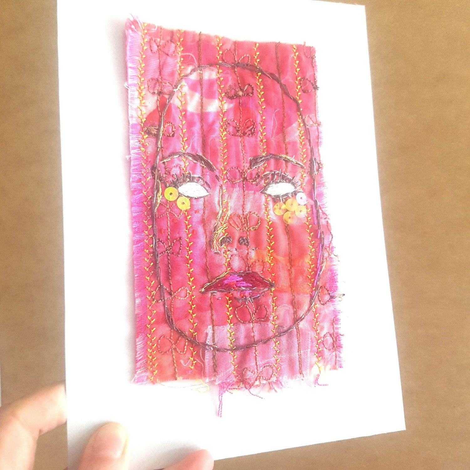 Textile art on white A5 backing board.