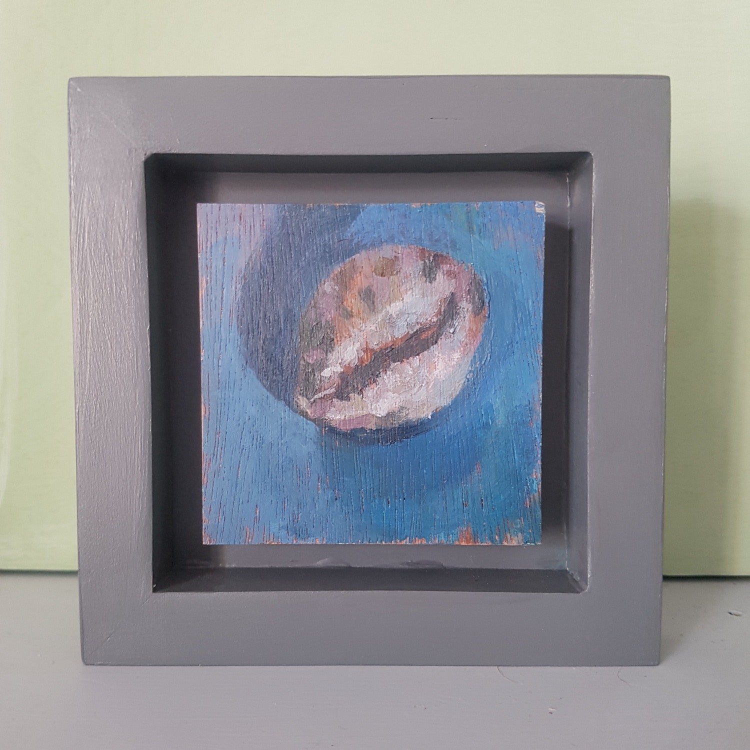 small cowrie shell study painted in acrylics on wood.