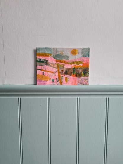 Abstract painting on a white wall next pale blue woodwork