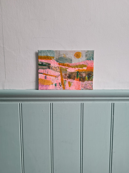 Abstract painting on a white wall next pale blue woodwork
