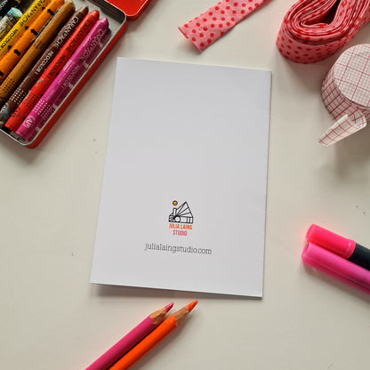 White card with a logo on a desk with stationery items