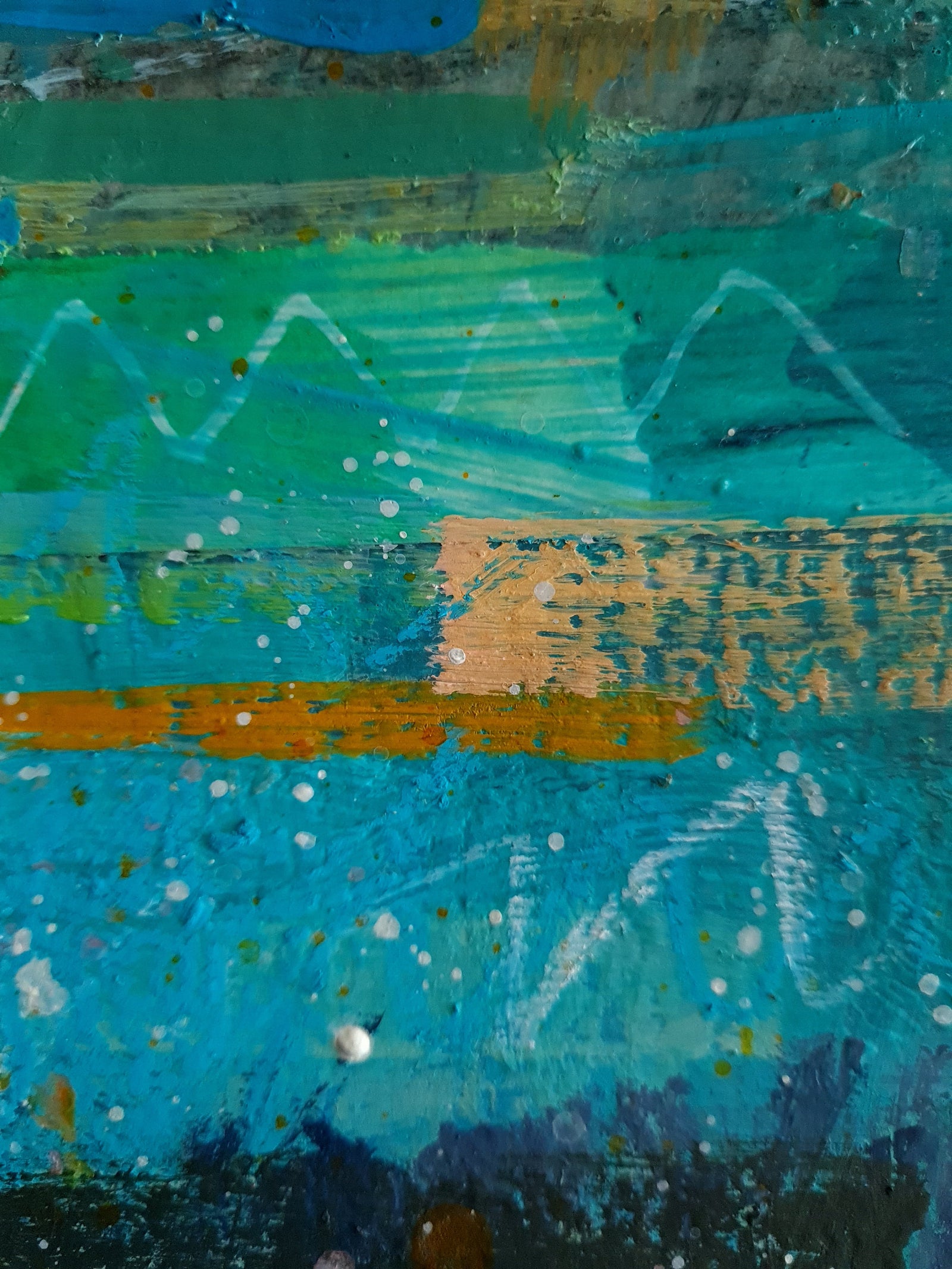 Abstract art close-up with a mix of blue, green, and orange colours.