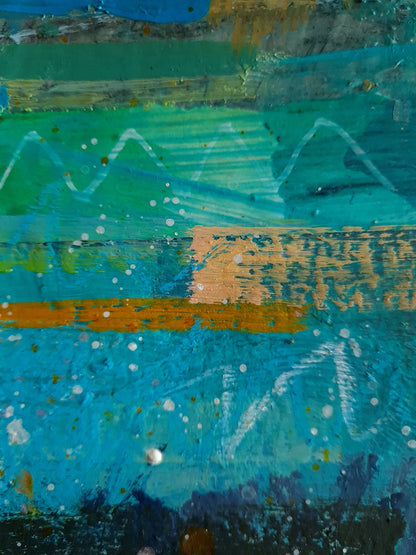 Abstract art close-up with a mix of blue, green, and orange colours.