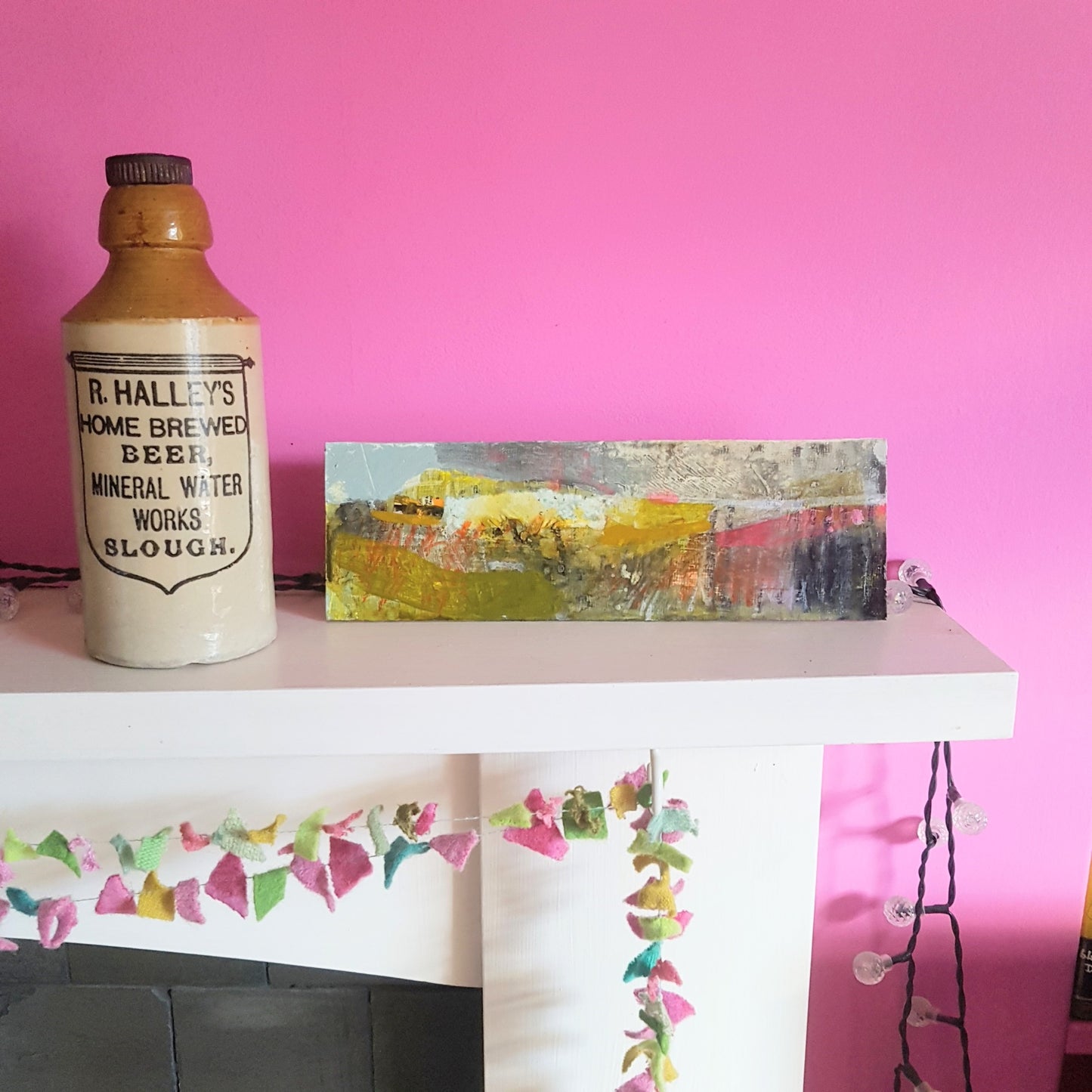 Misty Morning, horizontal landscape on a mantlepiece in a pink room.