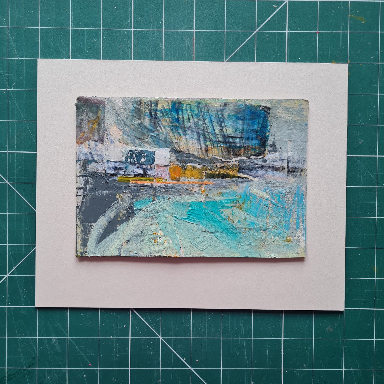 Abstract painting on a white card with a grid background
