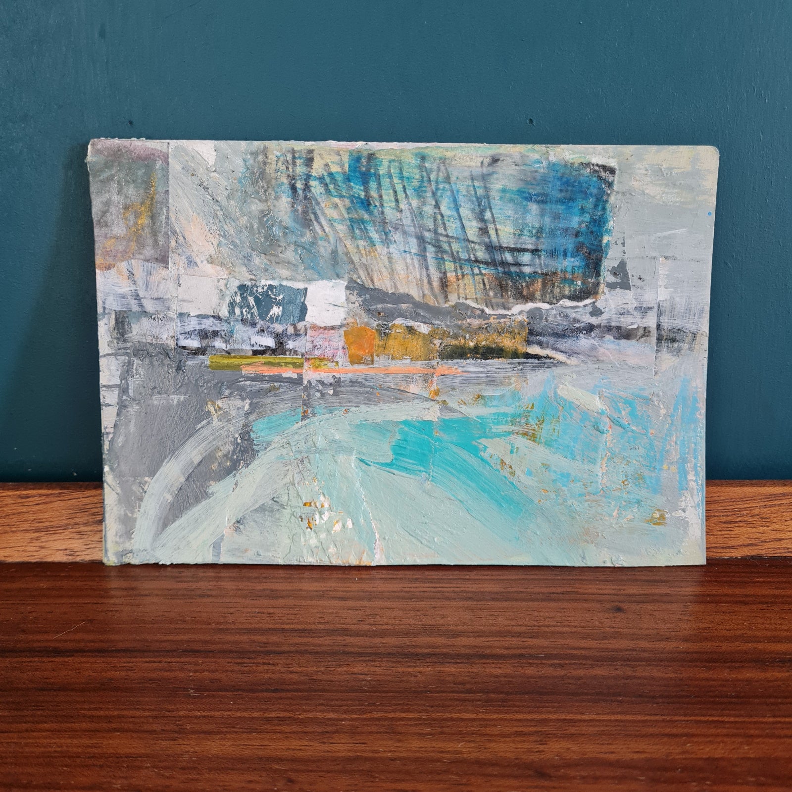 small painting on card in shades of blue, grey and turquoise acrylic paint.