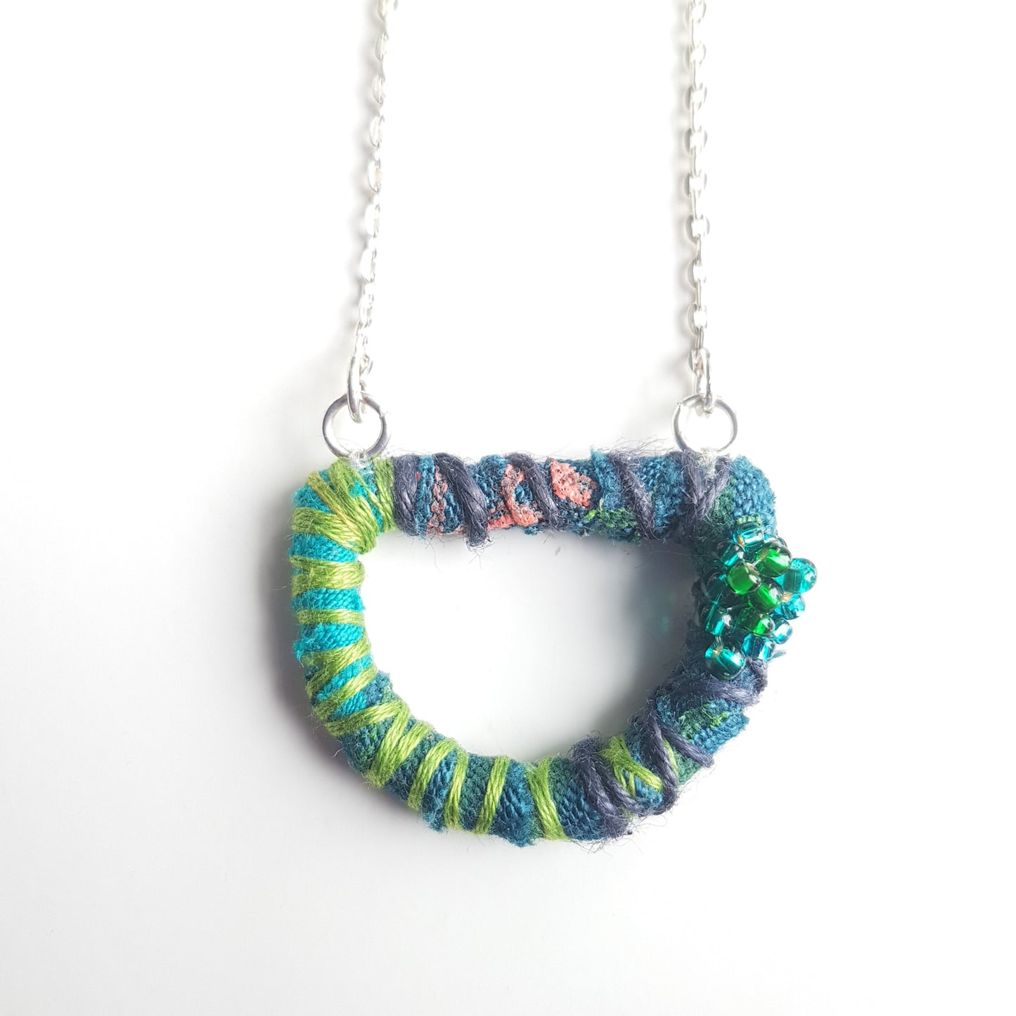 Teal and green textile art necklace with 18" silver plated chain.