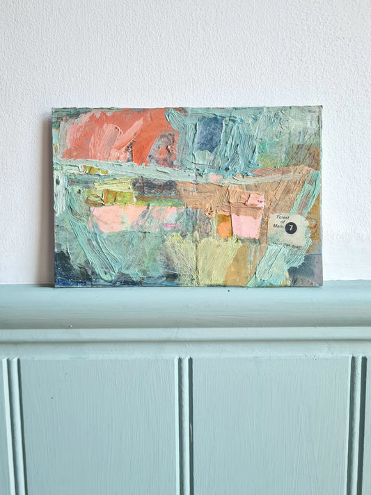 Vibrant abstract painting against a blue and white wall.