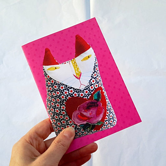 small pink notebook with cat design