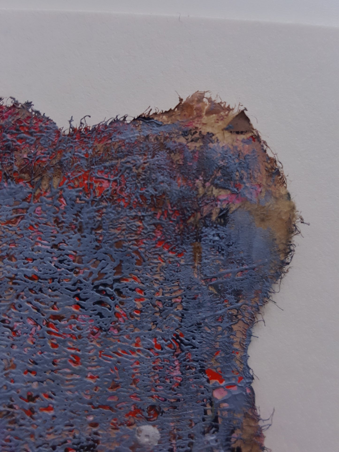 close up of torn edge of painting
