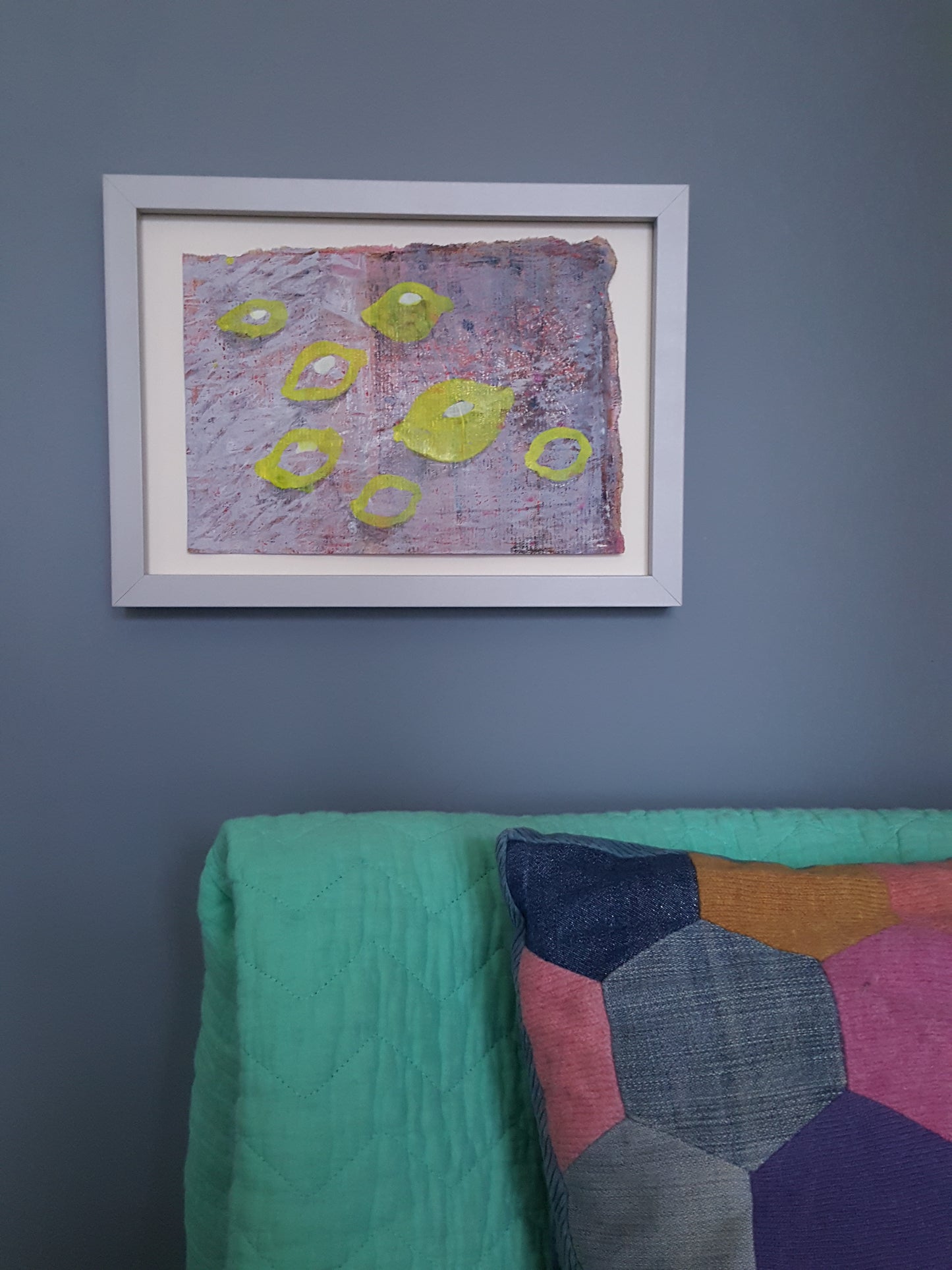 painting of lemons hanging on grey wall