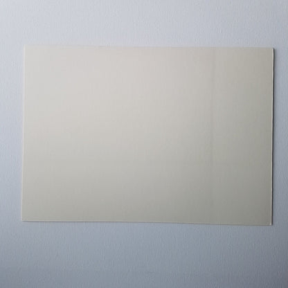 Back of cream coloured mounting board on a white background.