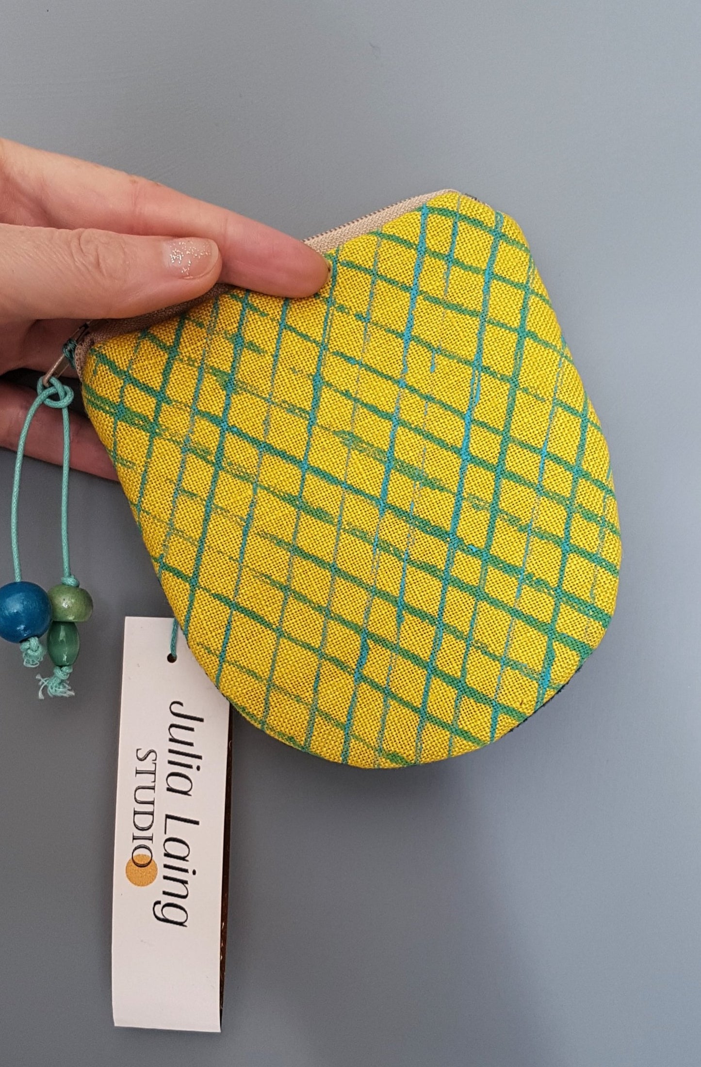 yellow handprinted purse with hanging tag.
